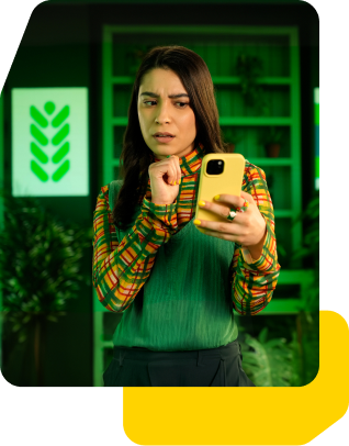A woman in a plant shop looking at her phone with a surprised expression