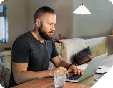 Man sitting typing on a laptop.
